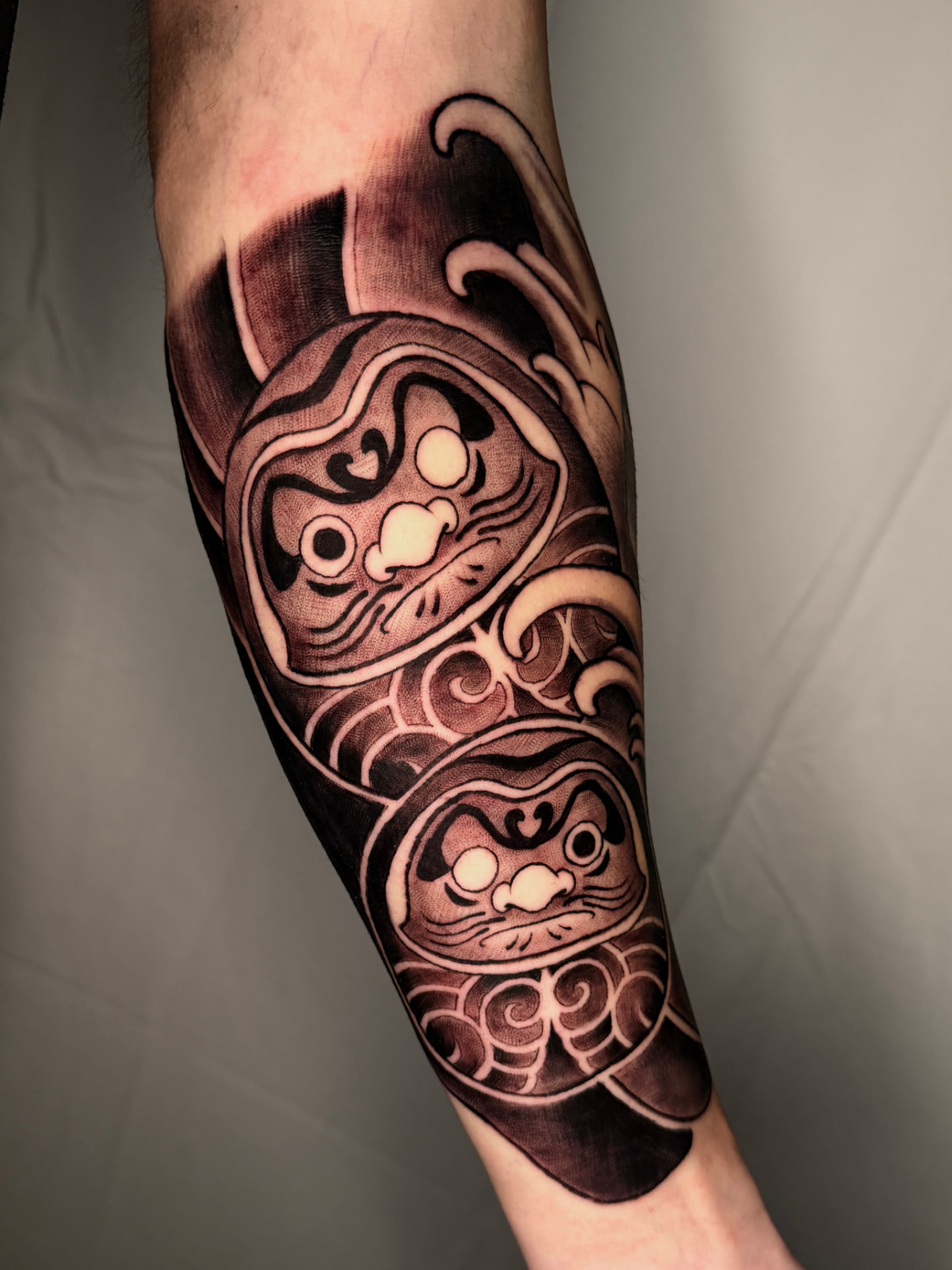 Daruma and waves forearm
